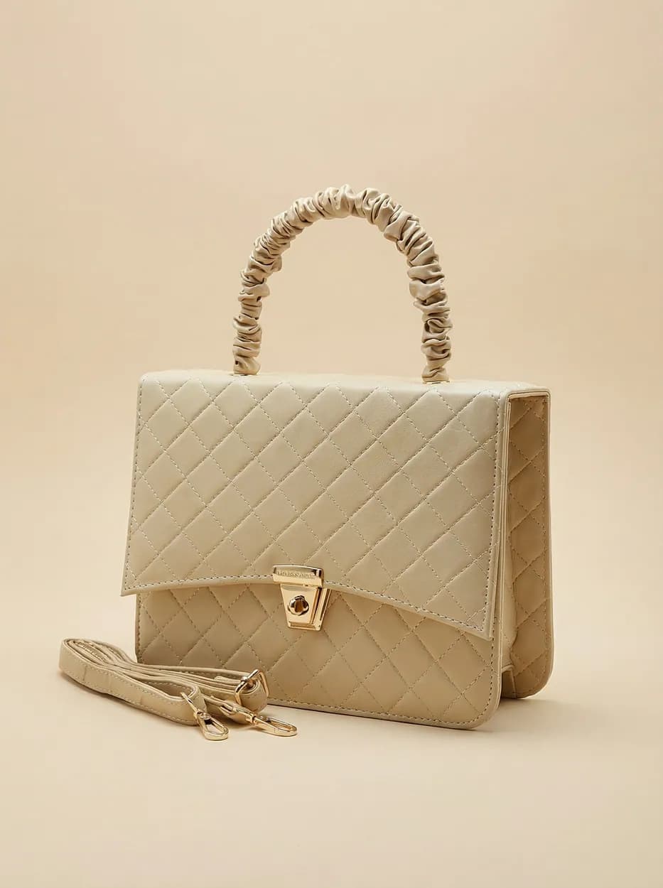Quilted beige ZARVA handbag with a gathered top handle and gold clasp
